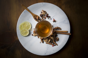 Food background with different black and green dry tea, rose buds cup of hot tea
