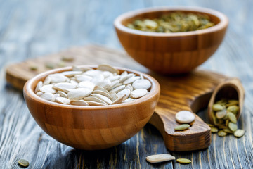 Pumpkin seeds in wooden bowls.