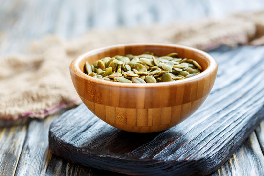 Cleaned the pumpkin seeds in a wooden bowl.