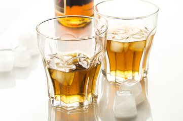 whiskey with ice in glass glasses