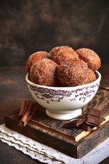 Stack of homemade fried vanilla donut with cinnamon,sugar and chocolate sauce.