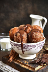 Stack of homemade fried vanilla donut with cinnamon,sugar and chocolate sauce.