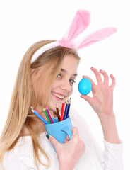 happy easter girl in bunny ears with blue egg, pencil