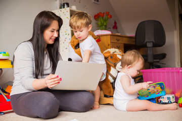 mother and children looking at laptop