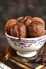 Stack of homemade fried vanilla donut with cinnamon,sugar and chocolate sauce.