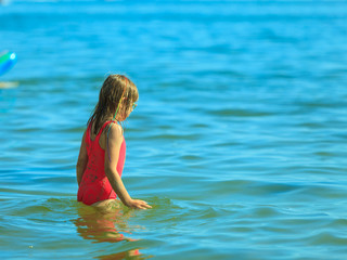 Little girl kid in sea water. Fun