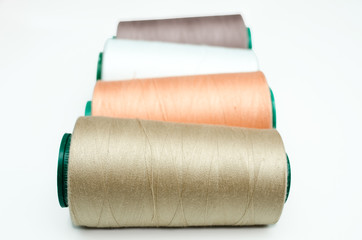 Spools of thread various color on a white background