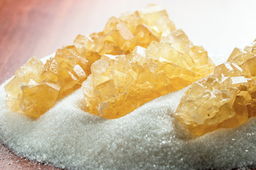 crystal sugar on a background of granulated sugar on the table