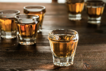 whiskey with ice on a wooden table