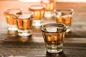 whiskey with ice on a wooden table