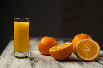 Orange fruit cut and orange juice on wooden table background,