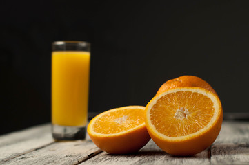 Orange fruit cut and orange juice on wooden table background,