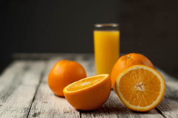 Orange fruit cut and orange juice on wooden table background,
