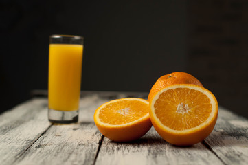 Orange fruit cut and orange juice on wooden table background,