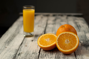 Orange fruit cut and orange juice on wooden table background,
