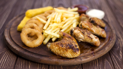 Fresh beer snacks assortment on dark wood board