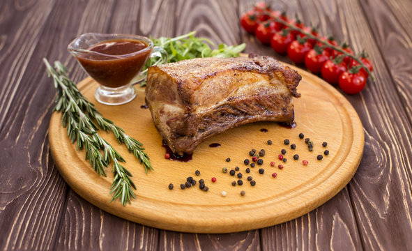 Pork on a wood background with sauce