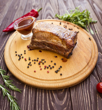 Pork meat with vegetable on wood board