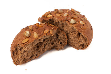 round a bun with pumpkin seeds wherein is isolated on a white background