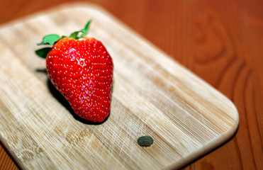 Fresh strawberry on wooden tray