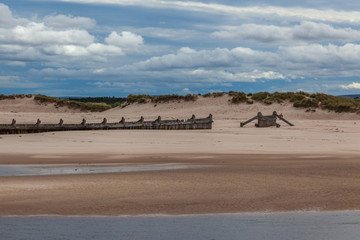 a sandy beach with a cloudy sky and sea