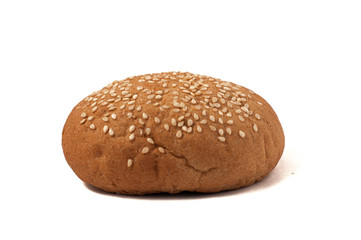 Hamburger bun with sesame seeds isolated on a white background