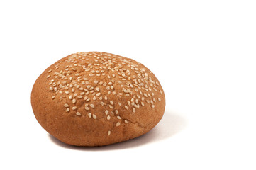 Hamburger bun with sesame seeds isolated on a white background