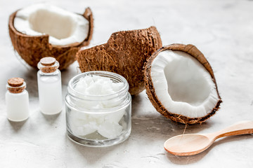 fresh coconut with cosmetic oil in jar on white background