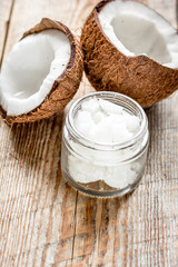 coconut oil for body care in cosmetic concept on old wooden table
