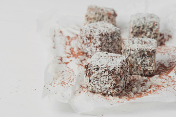 Raw sweets prepared from coconut and cocoa. Selective focus.