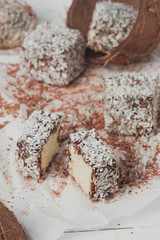 Raw sweets prepared from coconut and cocoa. Selective focus.