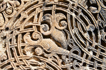 Detail of a beautiful old crumbling abstract stone decoration