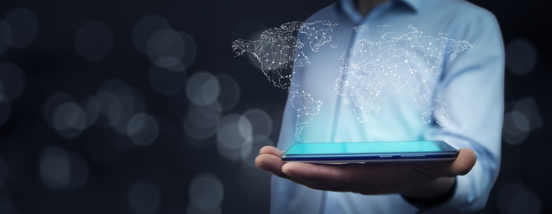 Business man hand phone and  touch screen with world map