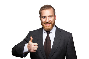Studio shot of attractive businessman. Happy businessman showing thumbs up, looking at camera, isolated on white..