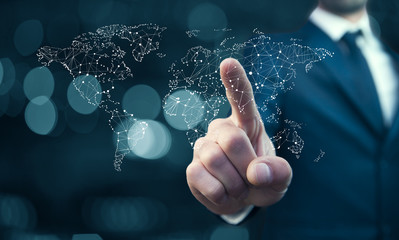 Business man pointing on the touch screen with world map