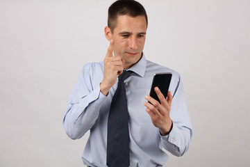 Furious businessman on mobile phone. Nervous man with smarth, celular phone.