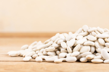 Pile of white beans on the wooden table