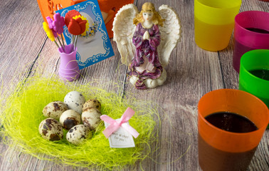 Colored Easter eggs table decoration with angel