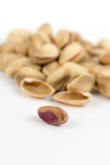Pile of roasted pistachio over white background