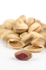 Pile of roasted pistachio over white background
