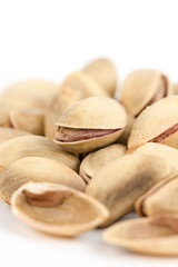 Fototapeta na wymiar Closeup macro roasted pistachio over white background
