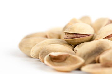 Closeup macro roasted pistachio over white background