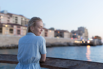 Fototapeta premium Woman enjoying her free time at the beach in the sunset time. Vacation time. Concept of holiday.