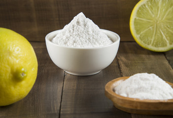 Lemon and baking soda on wooden table