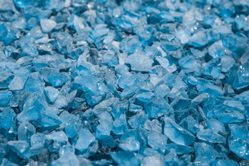 Small naturally polished blue crystal glass rock pebbles background. Miami. Florida. USA