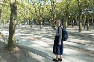 Portrait of a young woman walking in streets