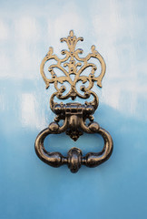 antique door-knocker on old door with beautifull texture