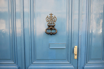 antique door-knocker on old door with beautifull texture