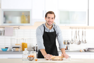 Man preparing pasta on kitchen table