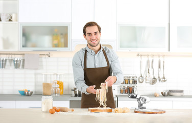 Man preparing pasta on kitchen table